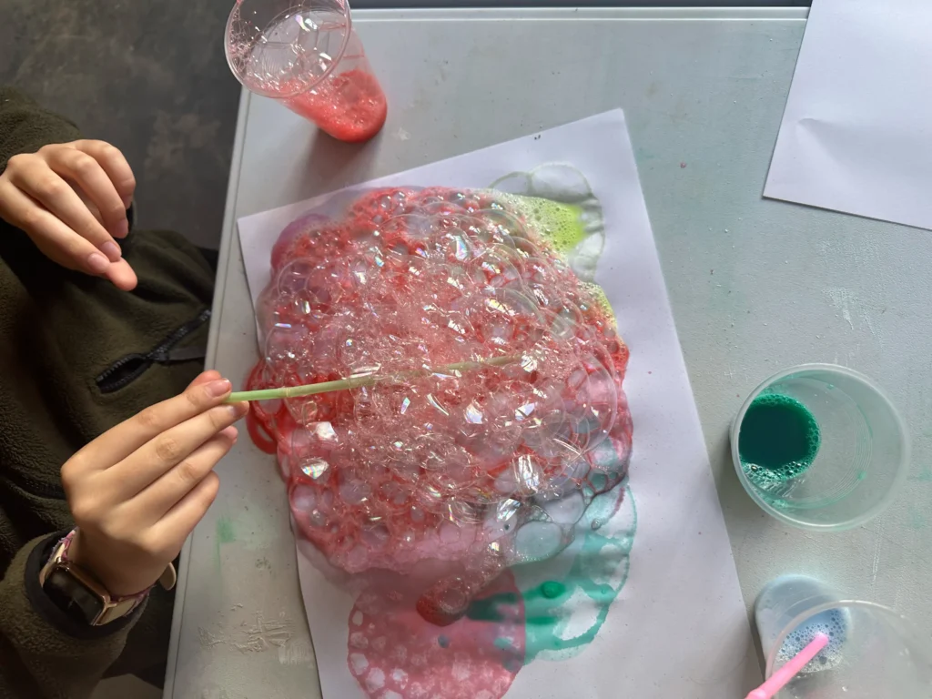 student paining with pink bubbles