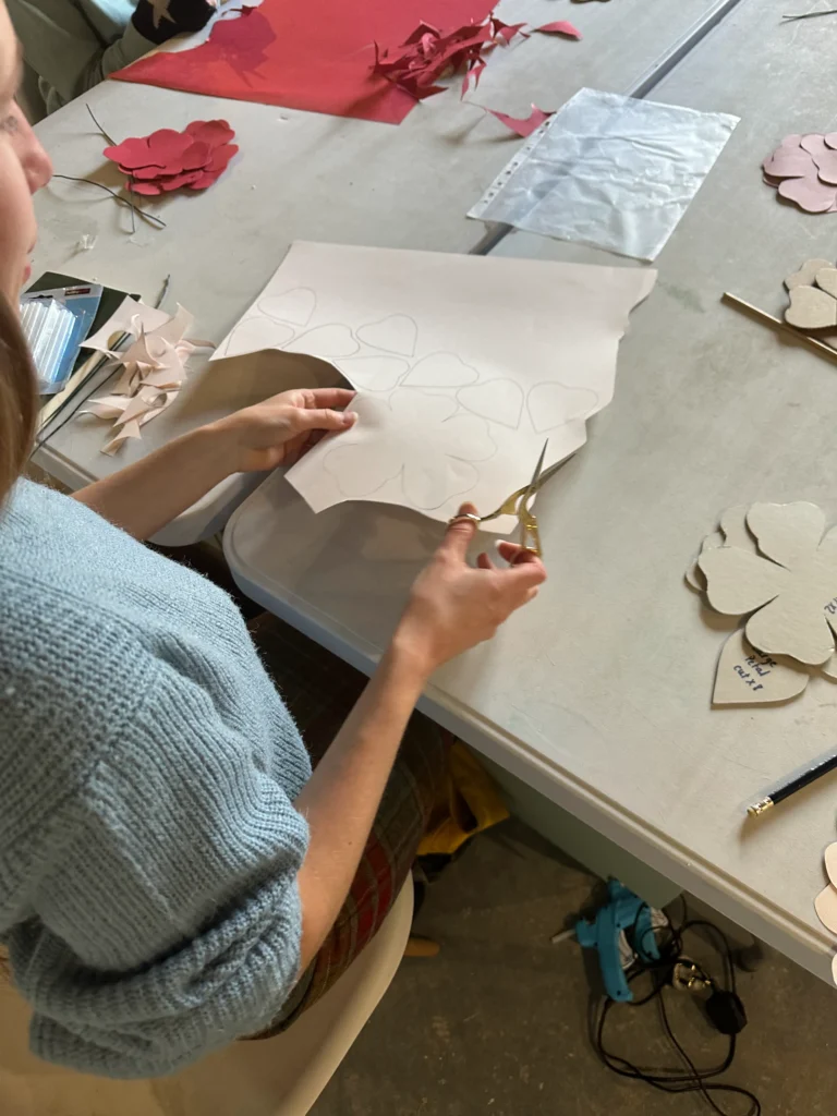 student using and cutting paper to create art