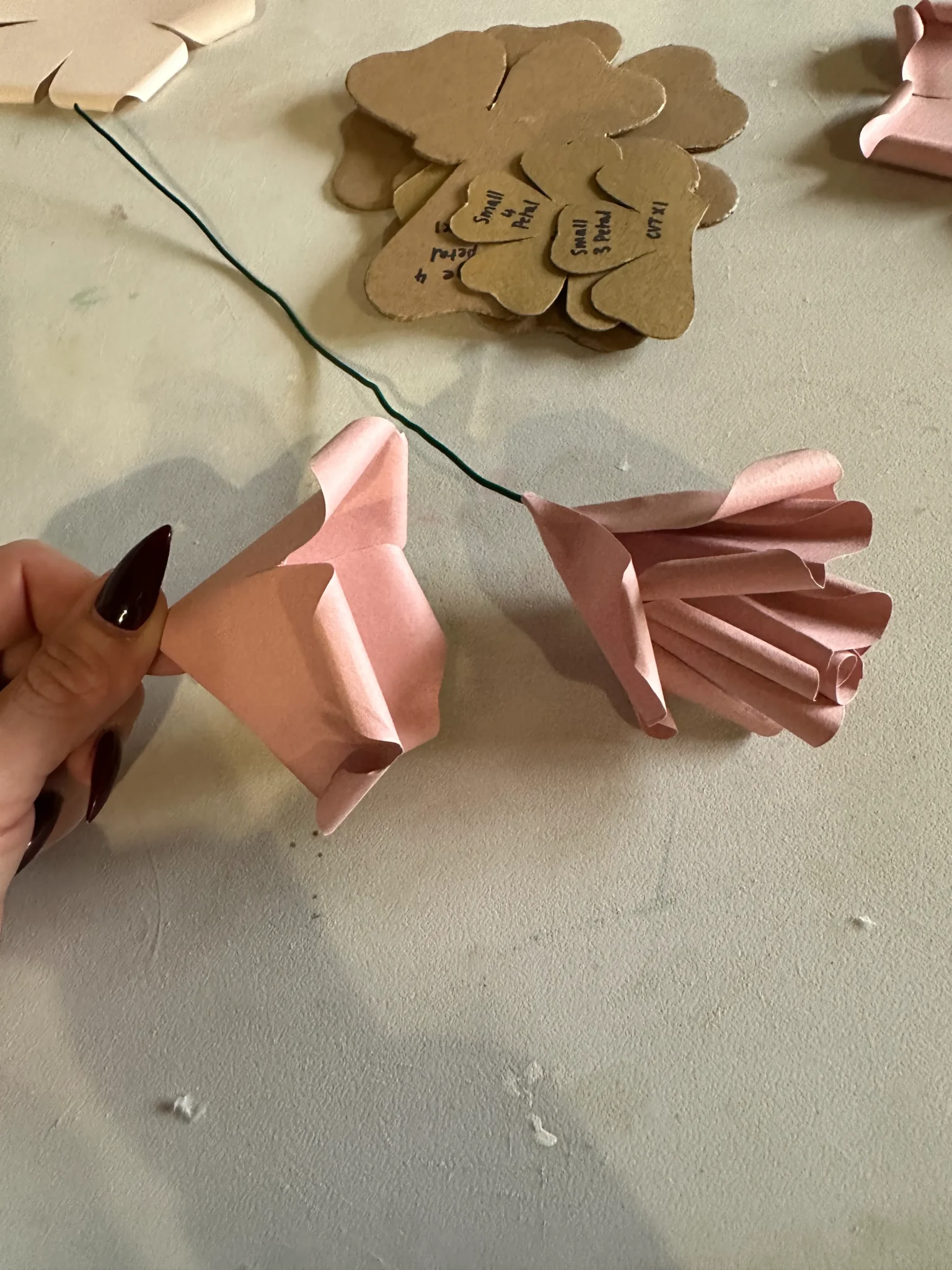 pink paper flowers created by students at be creative