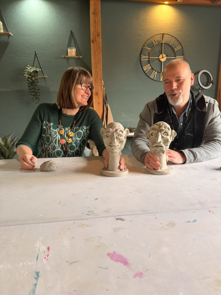 a photo of staff and their clay sculptures
